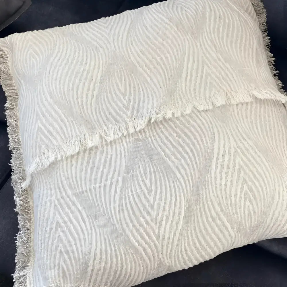 Linen pillow with swirl woven design.