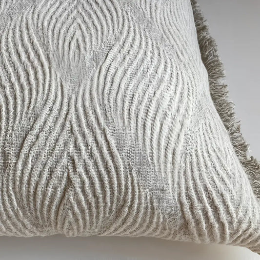 Linen pillow with swirl woven design.
