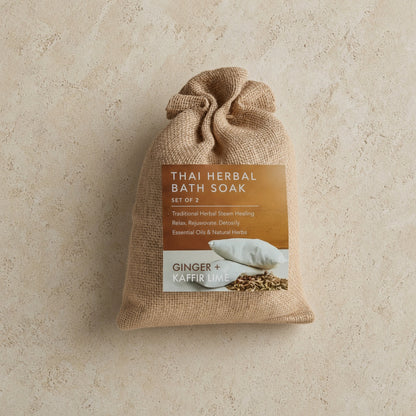 A beige burlap sack with a thai herbal bath soak handmade set featuring ginger and kaffir lime for soft skin