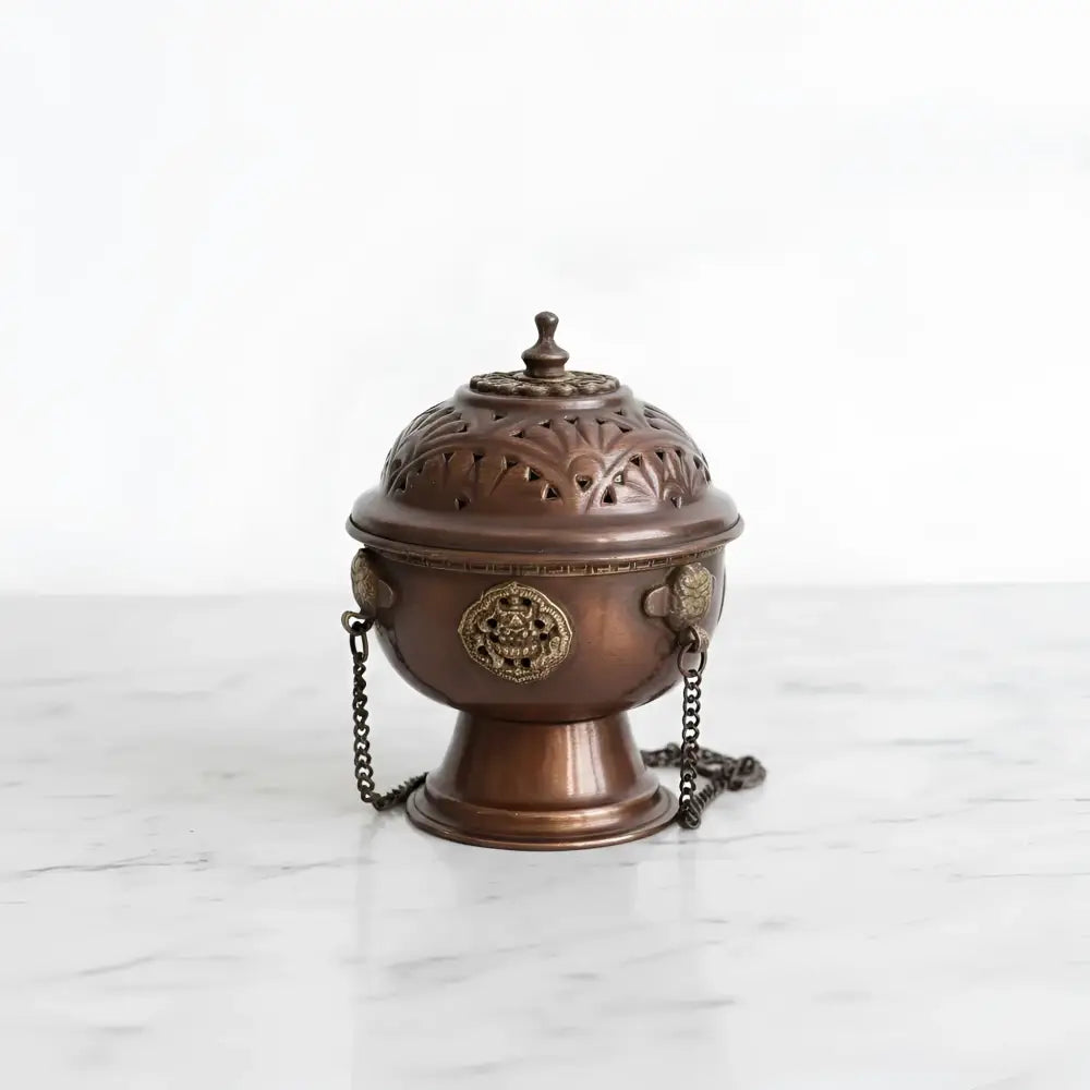 Antique bronze tibetan hanging incense burner with floral cutouts, golden medallions, and decorative chain for carrying