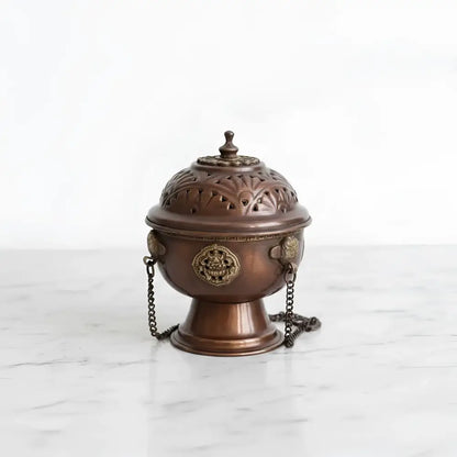 Antique bronze tibetan hanging incense burner with floral cutouts, golden medallions, and decorative chain for carrying