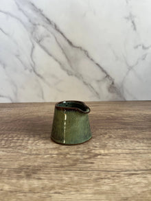 Small handcrafted green ceramic pitcher for syrup or cream
