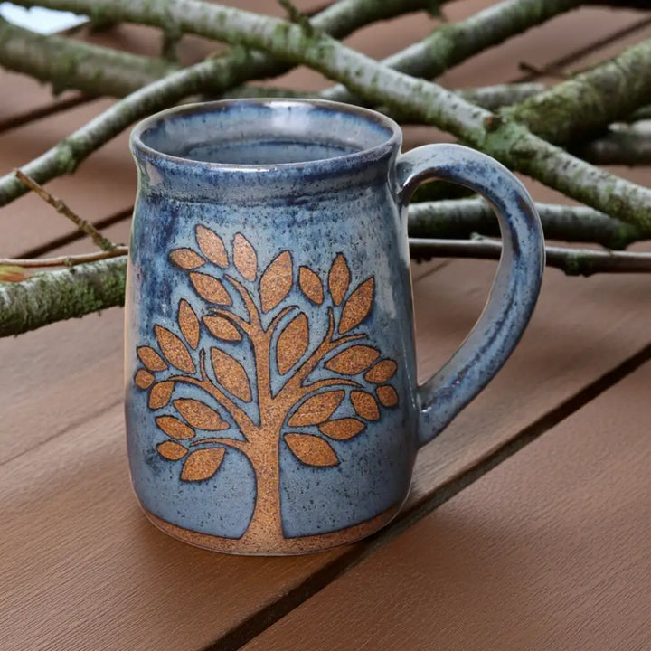 Gorgeous hand thrown tree mug in handmade pottery with blue glaze and etched design