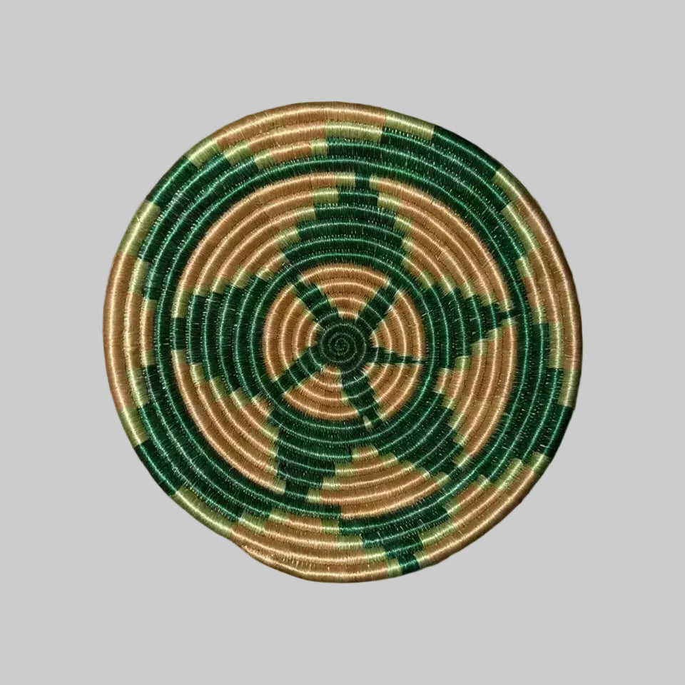 Handmade triangular small sisal bowl with hanging loop featuring deep green tan concentric rings and central starburst pattern