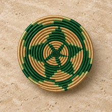 Handwoven african sisal bowl with vibrant green starburst pattern and natural tan rings, approximate size small