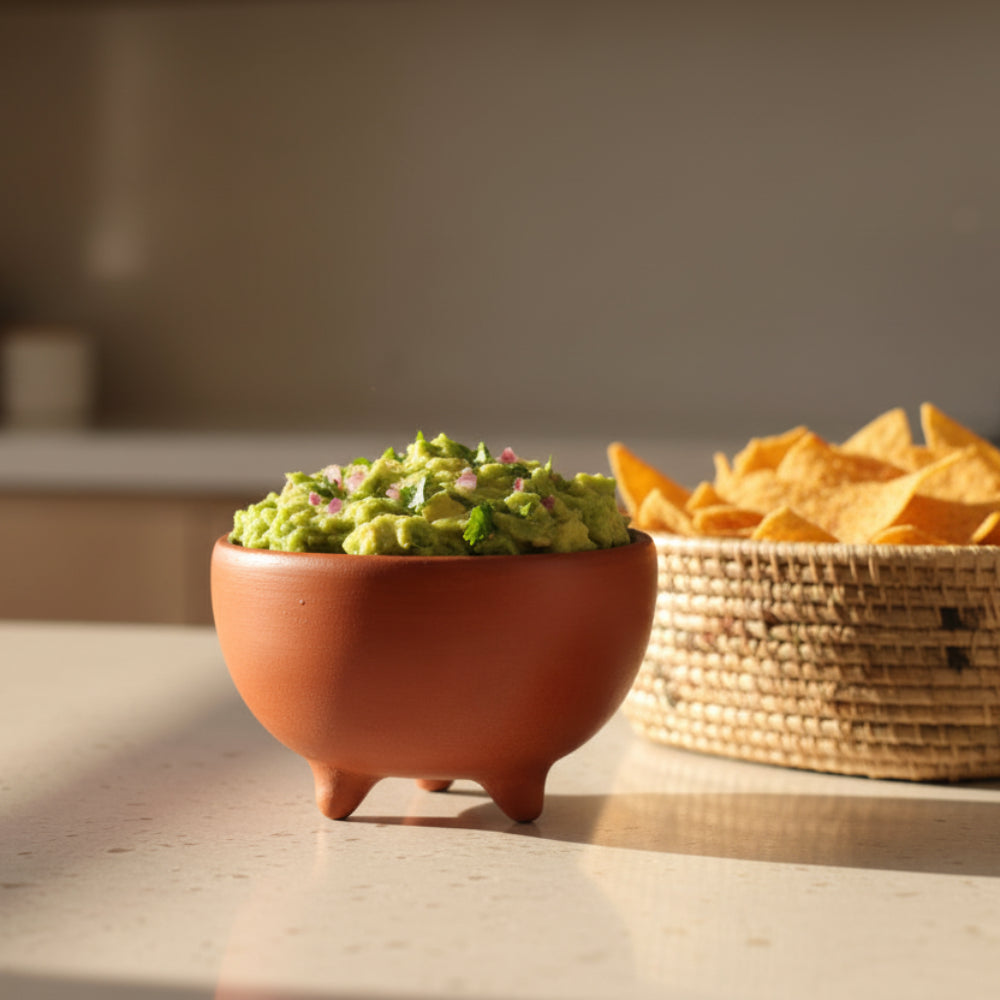 Handmade barro rojo tripod bowl from Oaxaca, brimming with green coffee beans