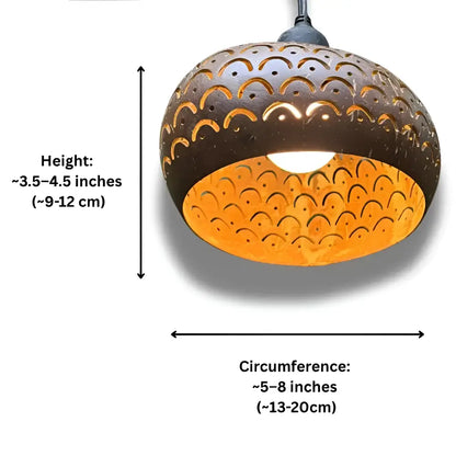 Dark brown handcrafted metal pendant light with intricate scalloped cutout patterns and warm orange glow coconut shades
