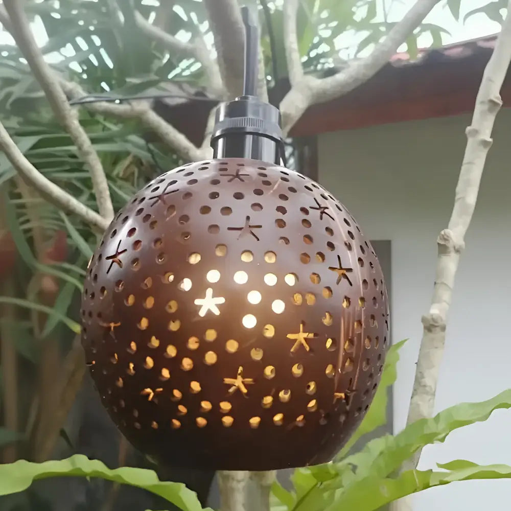 Bronze spherical outdoor lantern with star cutouts and black mount from tropical coconut patio string light shades coconut shells