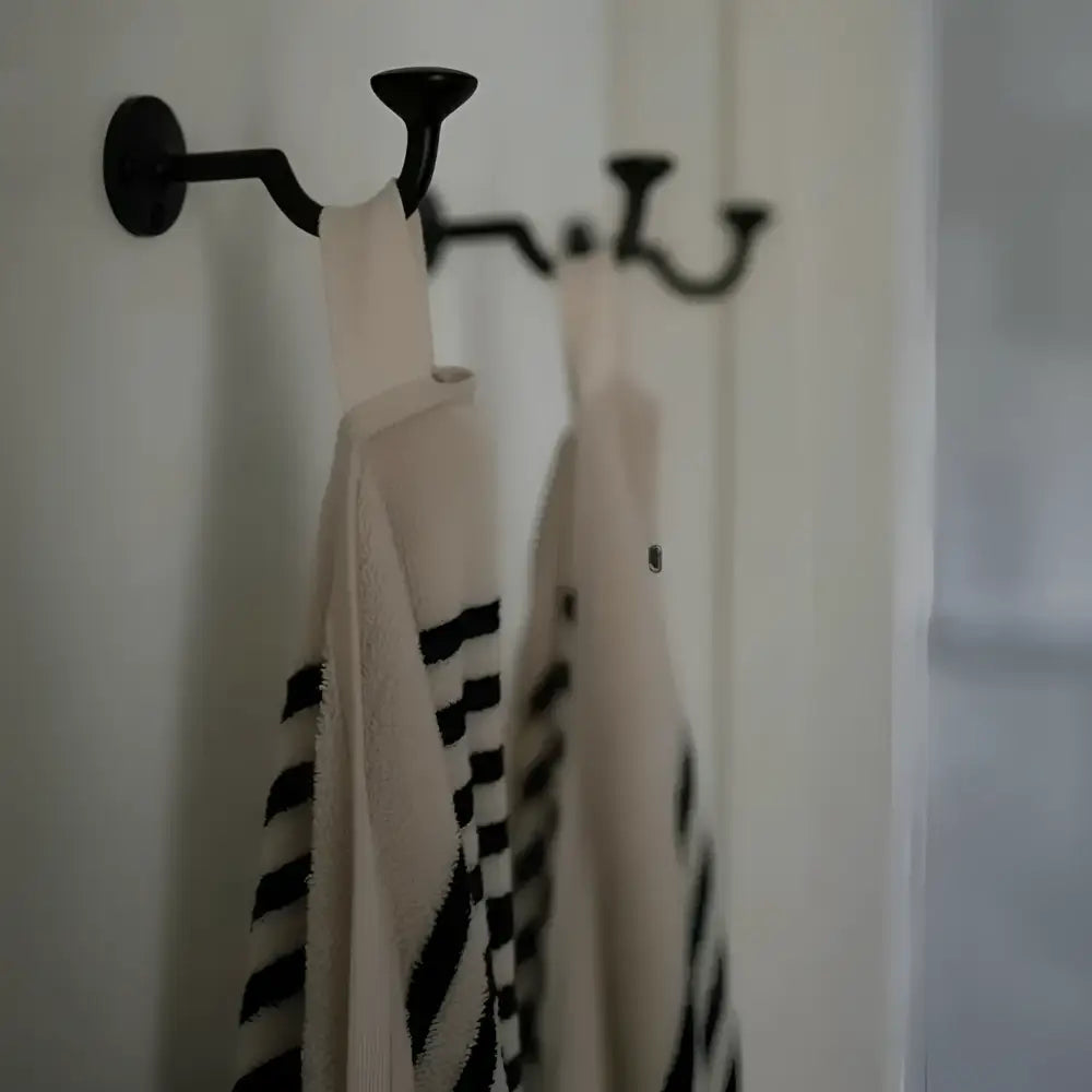 Black metal rack with Melika Turkish cotton striped towels