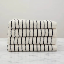 Stack of four Melika Turkish cotton striped towels in cream with bold black stripes