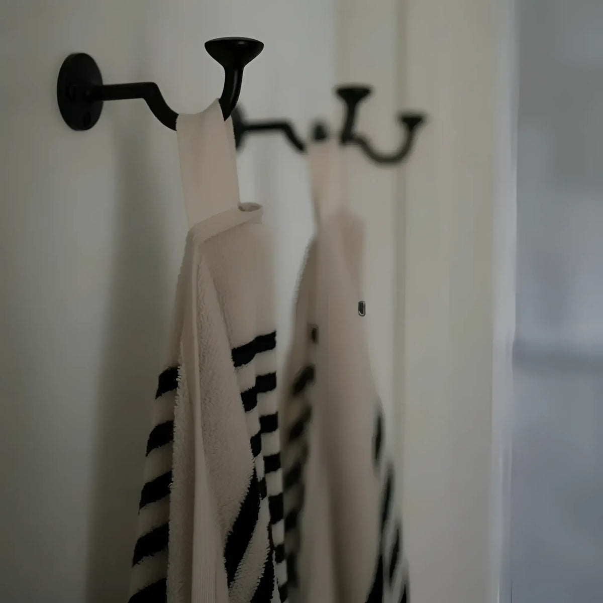 Black metal rack with Melika Turkish cotton striped towels