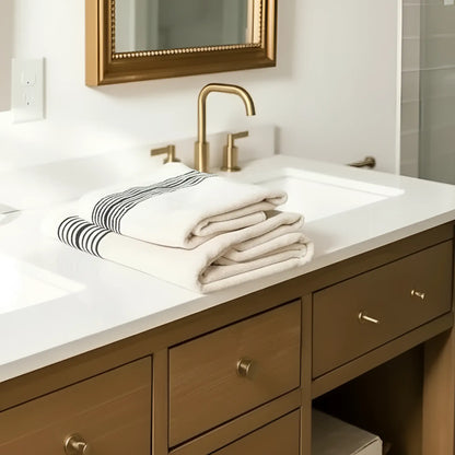 Neatly folded Melika Turkish cotton striped towel on bathroom counter