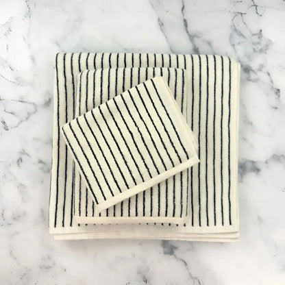 Stacked Turkish cotton striped towels in cream with black stripes