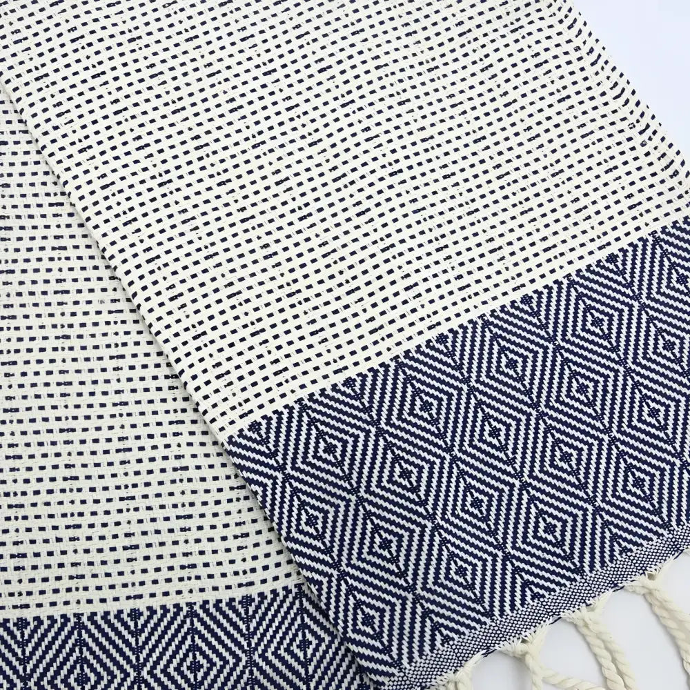 Turkish hand towel with diamond and dotted woven designs in navy blue.