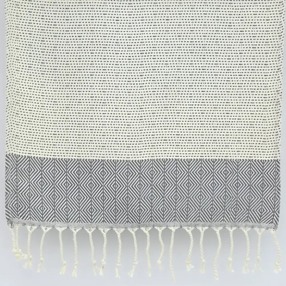 Turkish hand towel with diamond and dot woven design in gray.