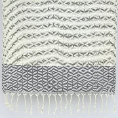 Turkish hand towel with diamond and dot woven design in gray.