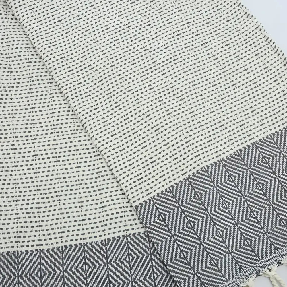 Turkish hand towel with diamond and dot woven design in gray.