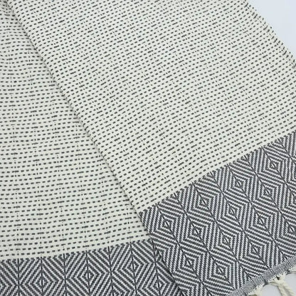 Turkish hand towel with diamond and dot woven design in gray.