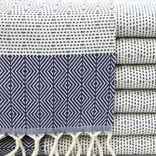Turkish hand towel with diamond and dotted woven designs in navy blue.