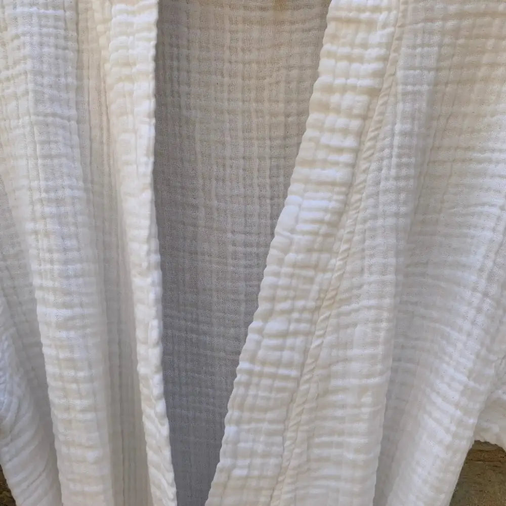 Close up of white muslin bathrobe