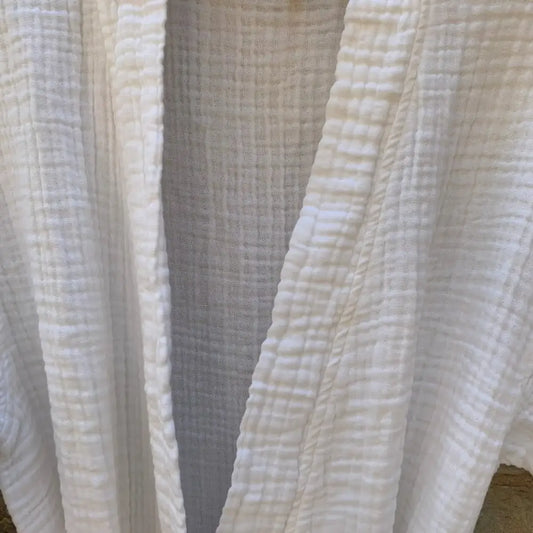 Close up of white muslin bathrobe