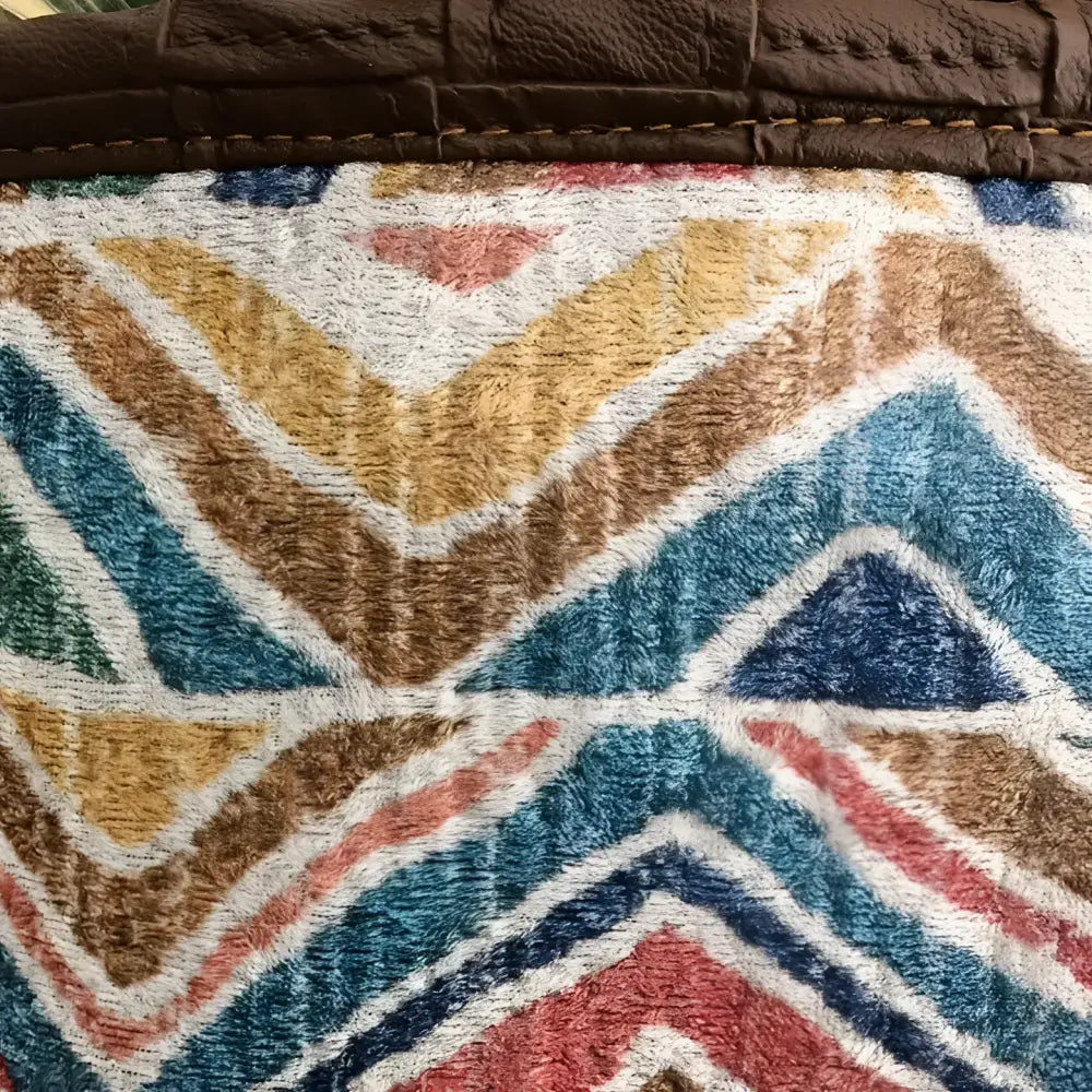 Soft basket created from Turkish rug remnants in colorful geometric design.