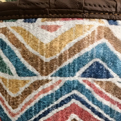 Soft basket created from Turkish rug remnants in colorful geometric design.