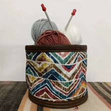Soft basket created from Turkish rug remnants in colorful geometric design.