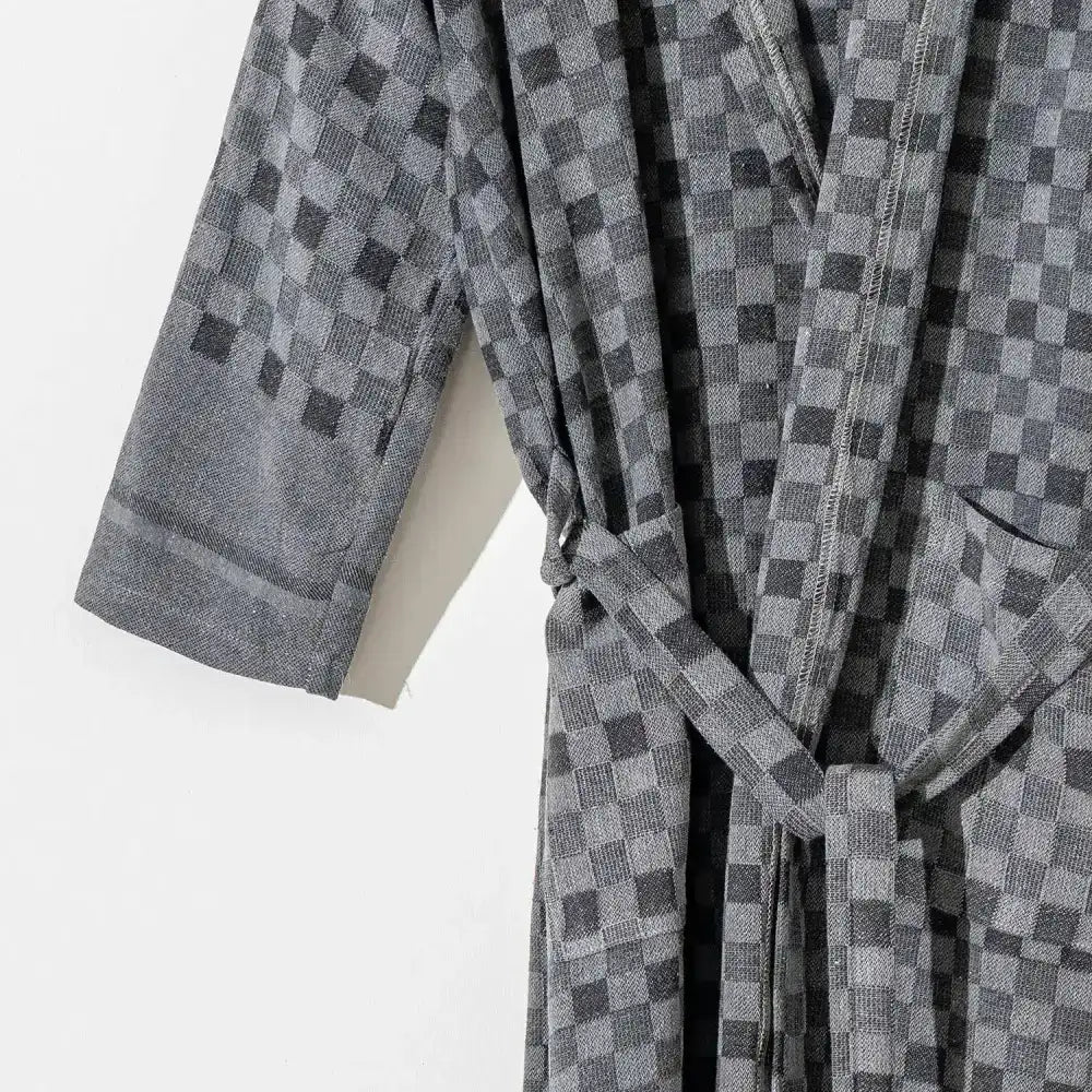 100% cotton robe with a flat woven Turkish towel texture and a hood in a checkered black color.