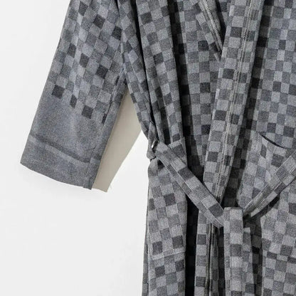 100% cotton robe with a flat woven Turkish towel texture and a hood in a checkered black color.