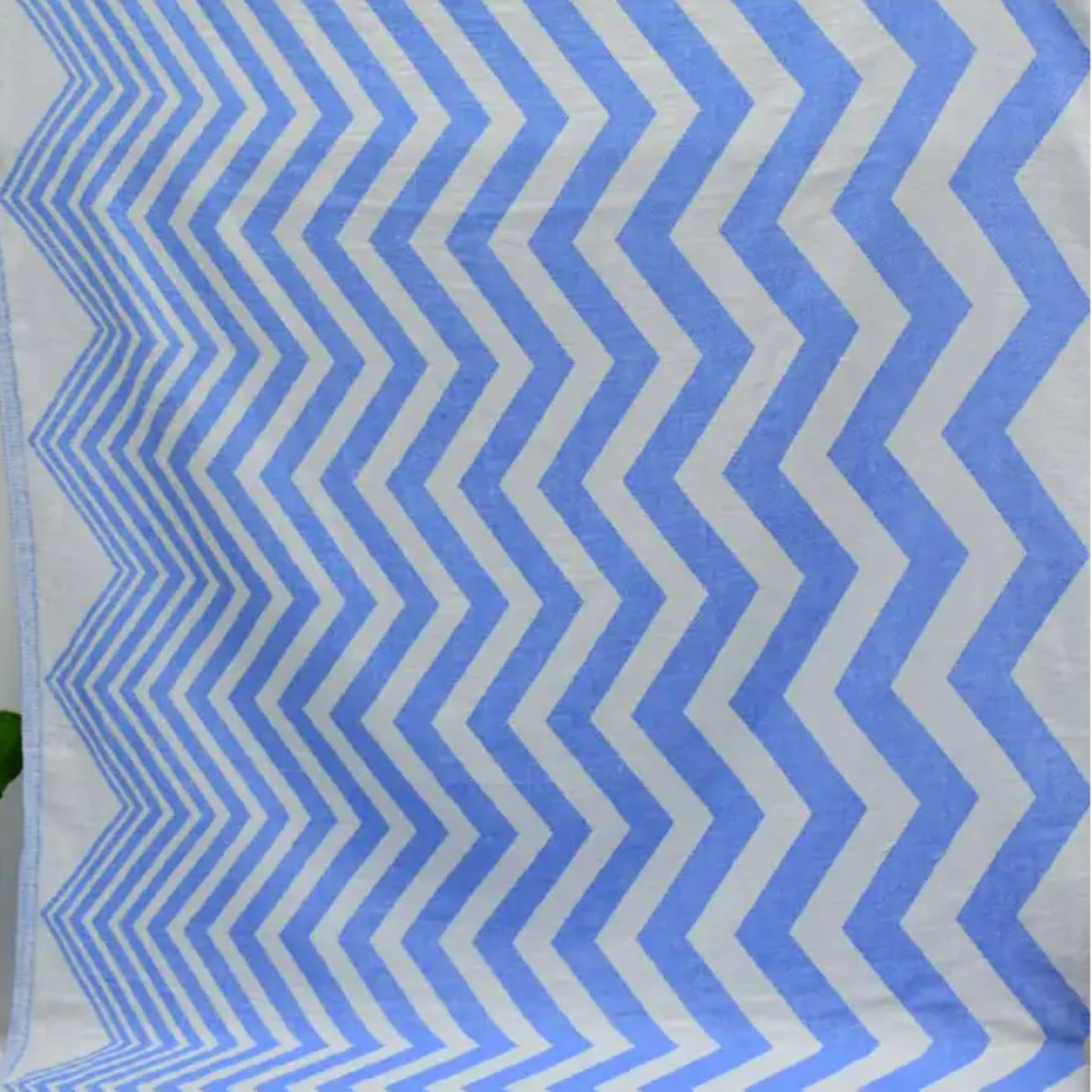 Turkish towel with a zigzag design in pale sax blue features a textured weave perfect for beach or bath use