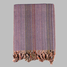 Striped multicolor Turkish beach towels with tassel fringe.
