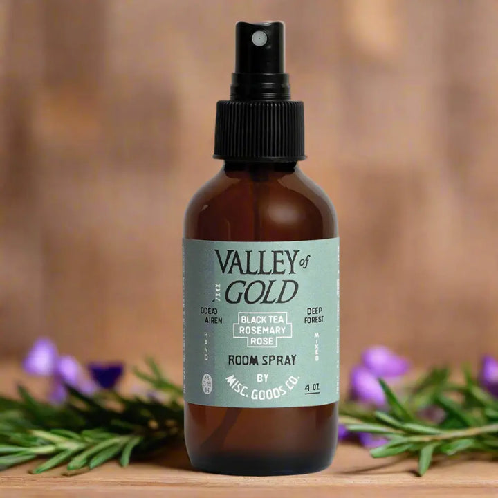Amber glass spray bottle of Valley of Gold Room Spray with wild garden rose geranium