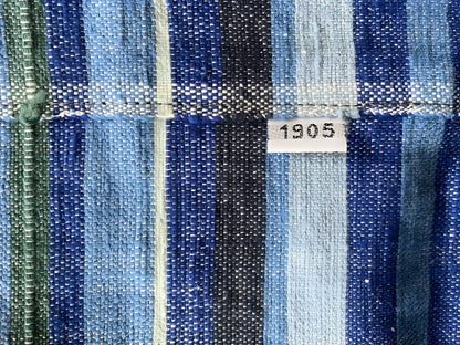 Vintage-style handmade ethiopian table runner with woven fabric in blue green and black stripes highlighting climate warming