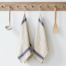 Two vintage linen kitchen towels with blue stripes on wooden rack