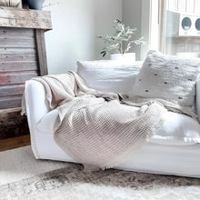 Sand colored waffle textured soft throw blanket.