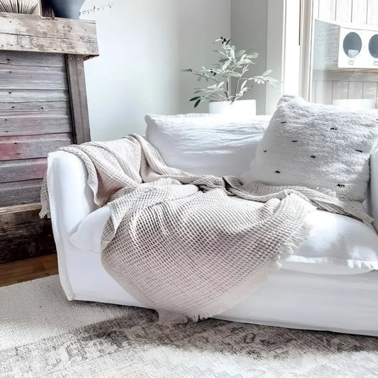 Sand colored waffle textured soft throw blanket.