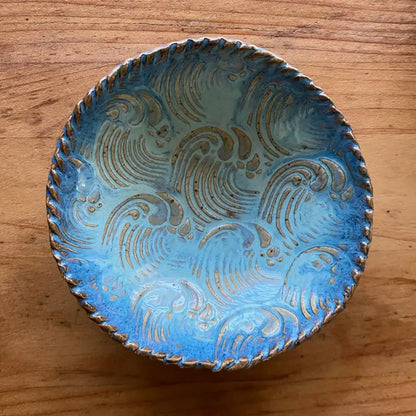 This small seafoam and blue handmade pottery dish features a natural wave texture.