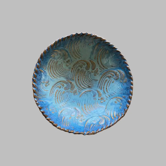 This small seafoam and blue handmade pottery dish features a natural wave texture.