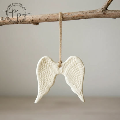 White ceramic angel wing ornament with twine hanger for year-round gifting