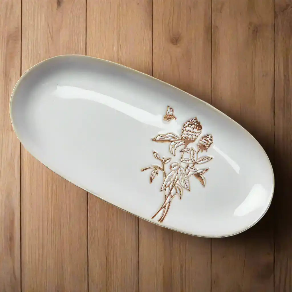 White ceramic honey small oval platter with embossed floral design for elegant serving