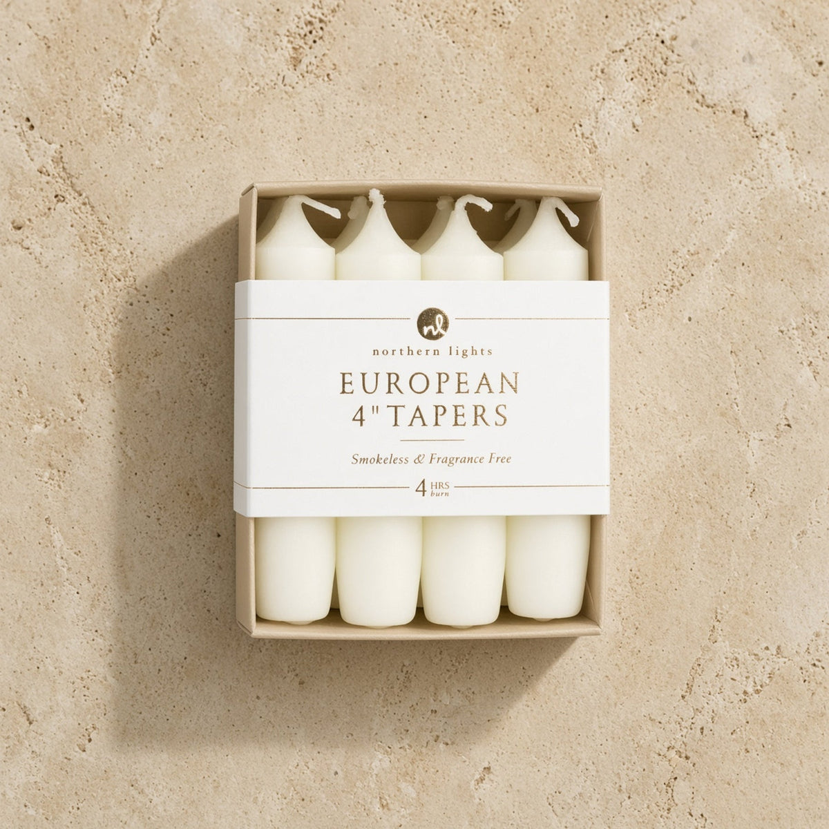 White unscented taper candles in a minimalist box labeled smokeless for standard taper holders 4 inch use