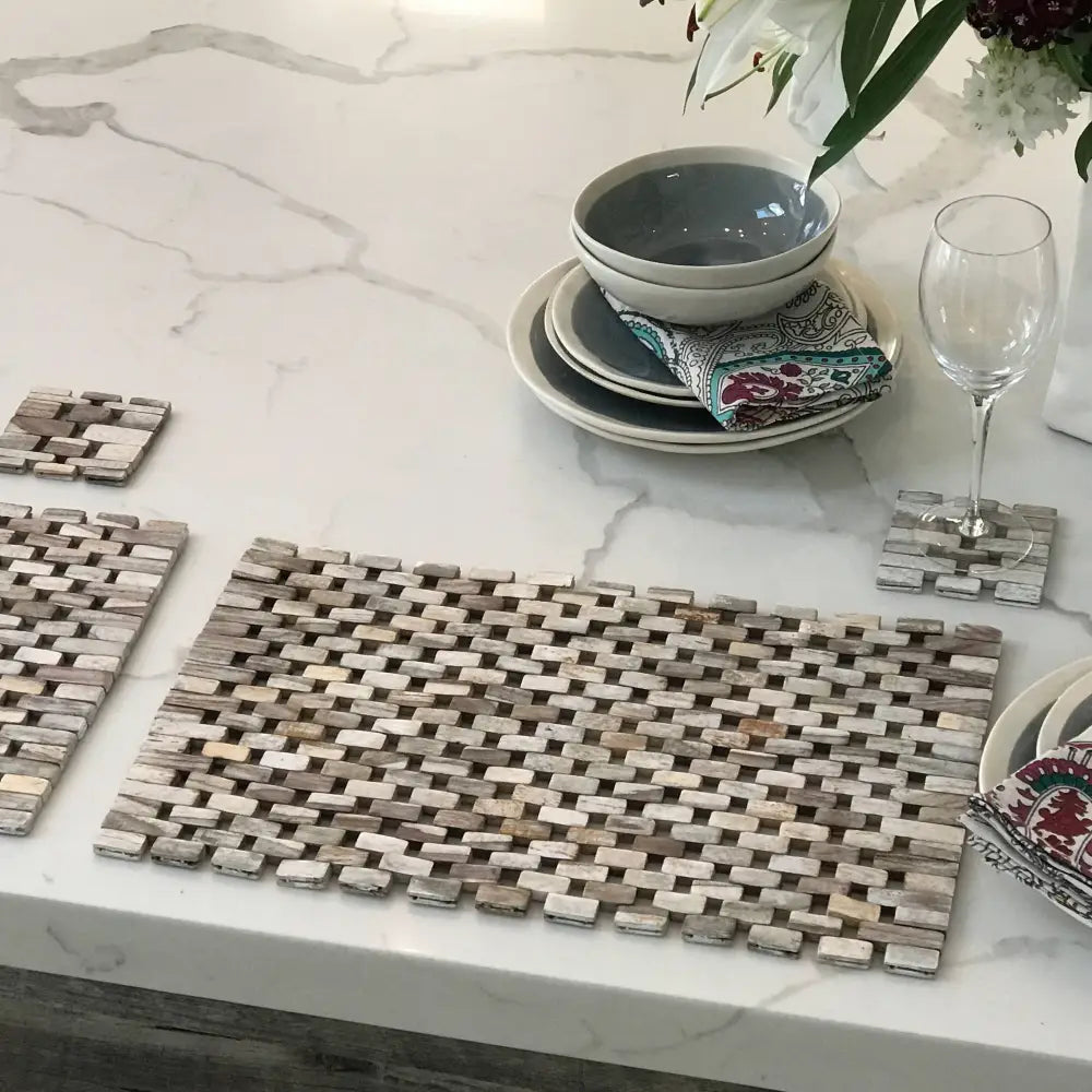 Woven wooden placemats and coasters with a subtle two-tone pattern in a sustainably harvested Rosewood placemat set