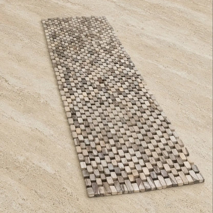 A woven bath mat made of natural stone tiles in beige and gray paired with a whitewash rosewood table runner