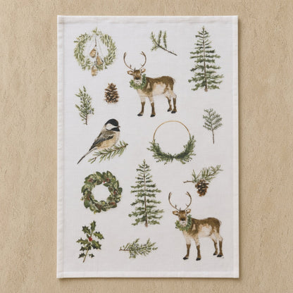 White tea towel with festive reindeer and pine design paired with african zulu trivet in natural tones