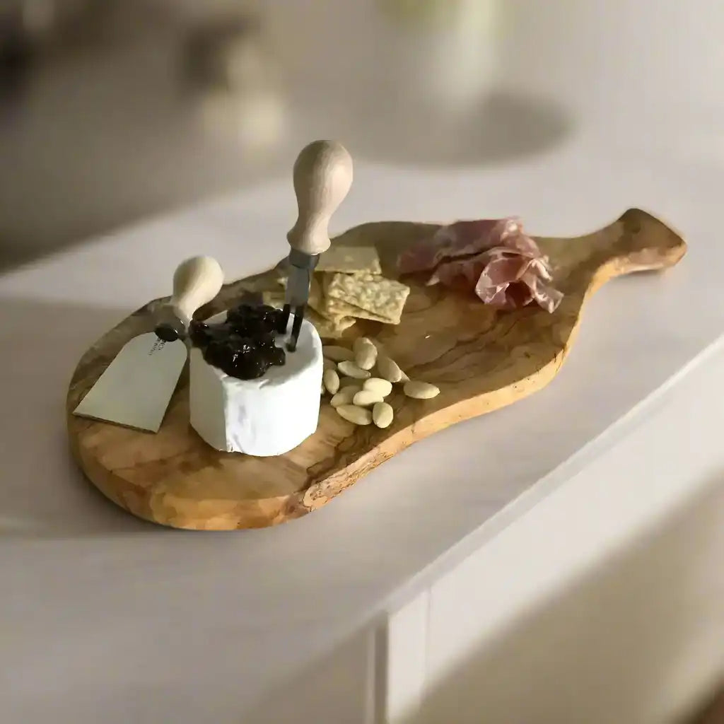 Italian Olivewood Charcuterie and Cheese Paddle Board with cheese on it on a white background