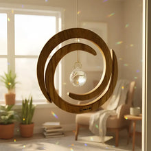 Handcrafted wood spiral ornament with a clear crystal sphere spinner hanging in the center