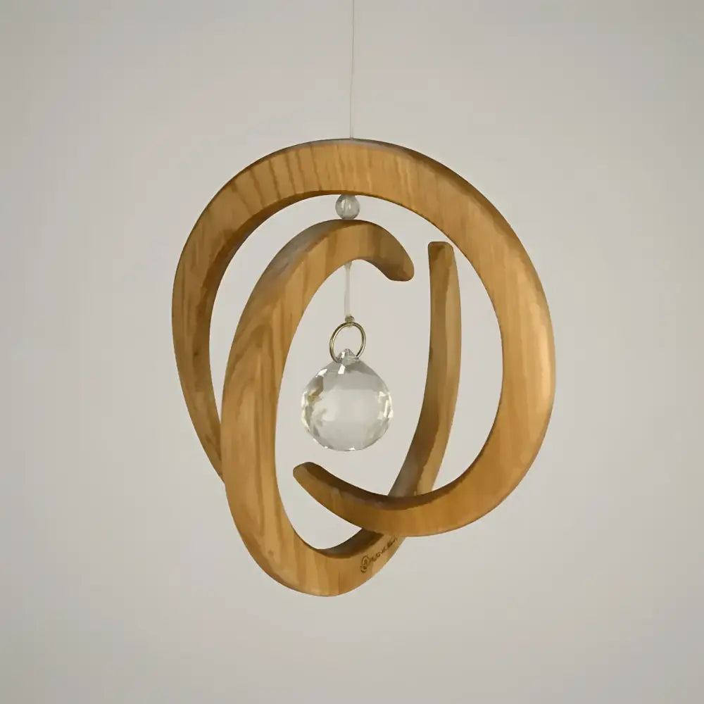 Handcrafted wood spiral ornament with circular design and clear crystal ball spinner in the center