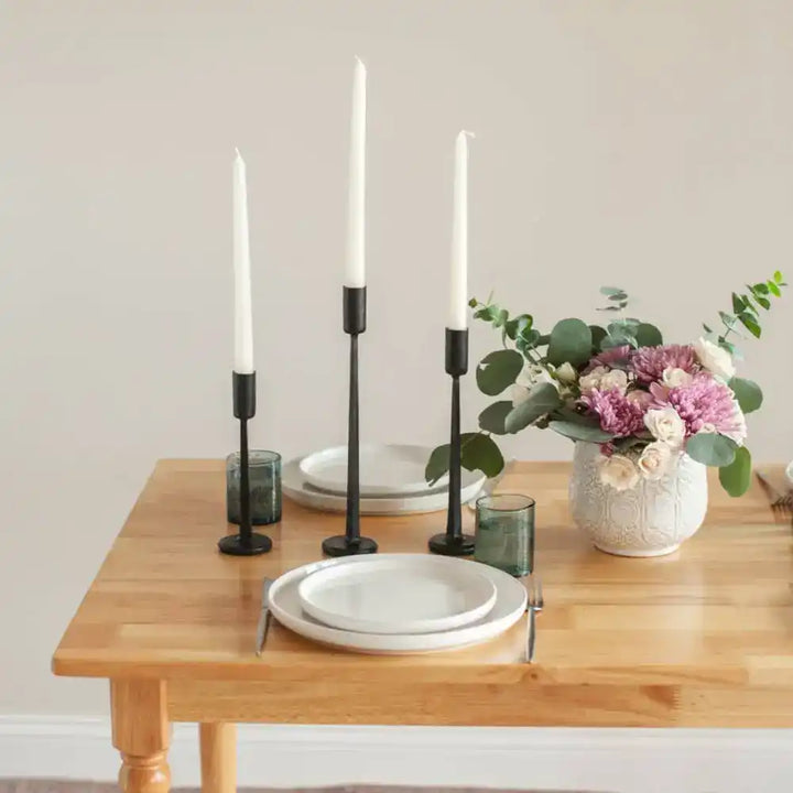 Hand Forged Iron Candle Stands set of three on wood table with place setting.