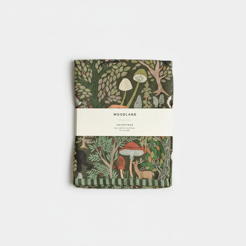 Woodland tea towel with green brown cover, forest animals and mushrooms